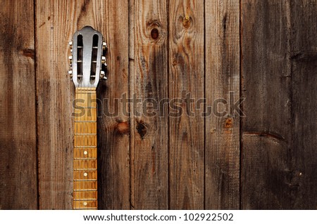 Guitar Neck on the old wooden wall