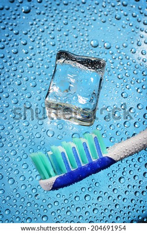 Toothbrush ice cube and water drop. Tooth sensitivity concept