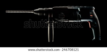 Professional rotary hammer with a drill on black background. With clipping path