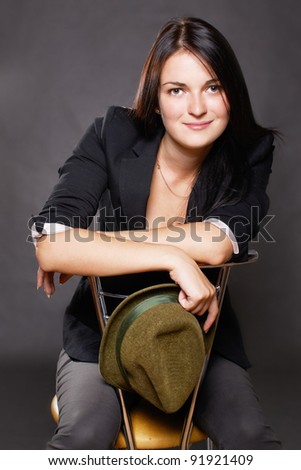 Portrait of smiling young woman sitting on chair