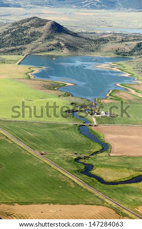 An aerial view of farmland and a small reservoir to store irrigation water