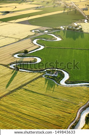 An aerial view of farmland and irrigation canals running throughout the fields.