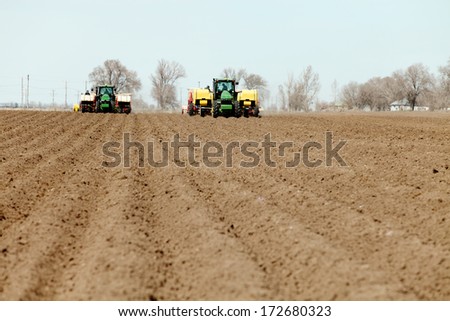 Fort Hall, Idaho, USA.  Apr. 12 2013  Tractors and other farm machinery working in the fields planting Famous Idaho Potatoes.