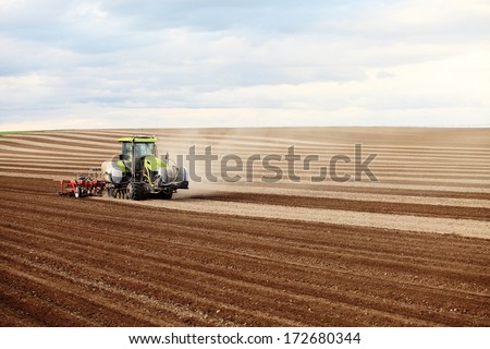 Rexburg, Idaho, USA.  Jun. 16, 2011  Tractors and other farm machinery plowing farm fields.