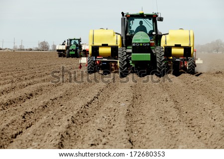 Fort Hall, Idaho, USA.  Apr. 12 2013  Tractors and other farm machinery working in the fields planting Famous Idaho Potatoes.
