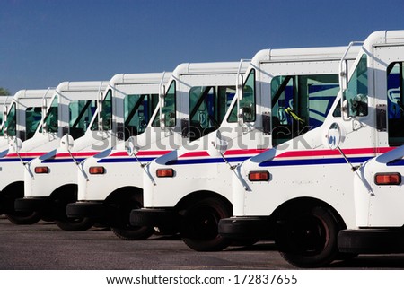 Idaho Falls, Idaho Jul. 14, 2010  A row of US Postal service trucks, parked waiting to deliver the mail.