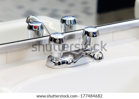 A water saving faucet in a modern public rest room