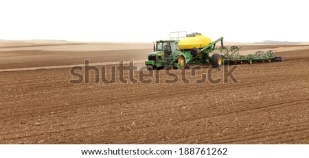 Rexburg, Idaho, USA Apr. 4, 2012  Farm machinery planting wheat in the fertile farm fields of  Idaho