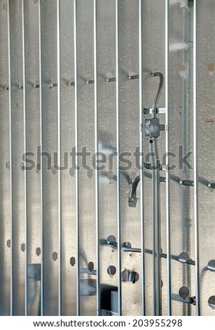 Steel studs with electrical conduit, used to frame in a large commercial building.