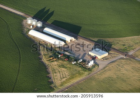 An aerial view of farm cellars for storing root vegetables with farm fields in the background