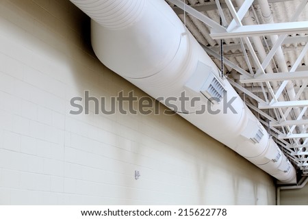 Exposed duct work hanging from a ceiling