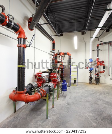 Idaho, USA June 4, 2014 The mechanical room of a geothermal energy heated building showing the plumbing and heat exchangers.