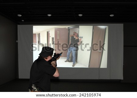 Idaho Falls, Idaho, USA Nov. 18, 2014,  A tactical weapons specialist trains for emergencies in a modern indoor shooting simulator.