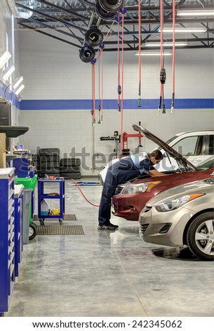Idaho, USA Oct. 3, 2014 A mechanic working on a car in a modern automotive repair shop