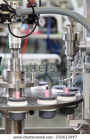 Idaho Falls, Idaho, USA  June 18, 2012 A vial filling machine in a cosmetics factory.