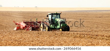 Rexburg, Idaho, USA Oct. 9, 2012- Farmers using farm machinery in the field harvesting potatoes.  The potatoes are dug, gently placed on top of undug rows of potatoes.