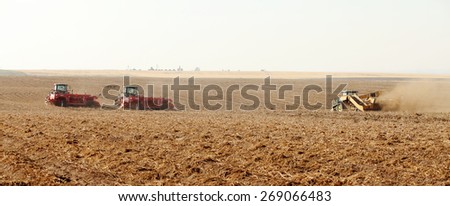 Rexburg, Idaho, USA Oct. 9, 2012- Farmers using farm machinery in the field harvesting potatoes.  The potatoes are dug, gently placed on top of undug rows, and picked up by a harvester.