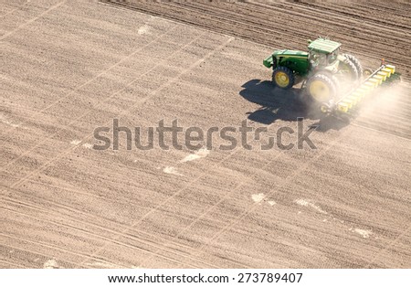 American Falls, Idaho, USA Apr. 17, 2015 An aerial view of farm machinery planting potatoes in the fertile farm fields of Idaho.