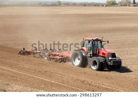 American Falls, Idaho, USA Apr. 17, 2015 A aerial view of a tractor plowing a farm field in preparation for spring planting.