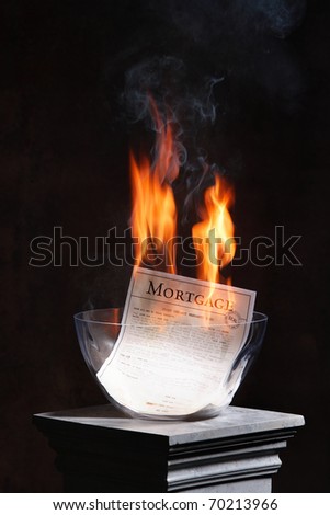 A home mortgage being burnt, celebrating the end of the mortgage