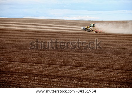 Image of a tractor plowing a field