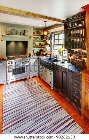 A modernized kitchen in a primitive colonial style reproduction home.   The styling is authentic primitive colonial, with modern amenities added to make the home functional and comfortable.