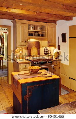 The kitchen in a primitive colonial style reproduction home. The styling is authentic primitive colonial, with modern amenities added to make the home functional and comfortable.