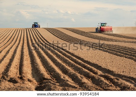 Farm machinery planting potatoes.