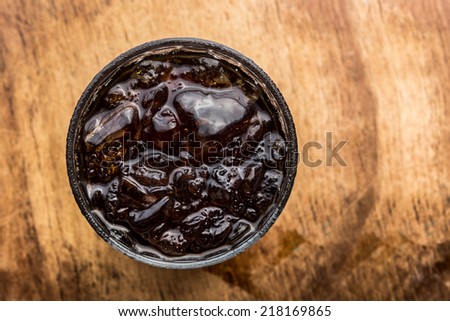 Iced black coffee on wood background