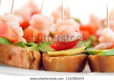 sandwiches  garnish with shrimps, avocado and lettuce close up, snack