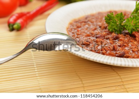 Bowl of chili with peppers and beans