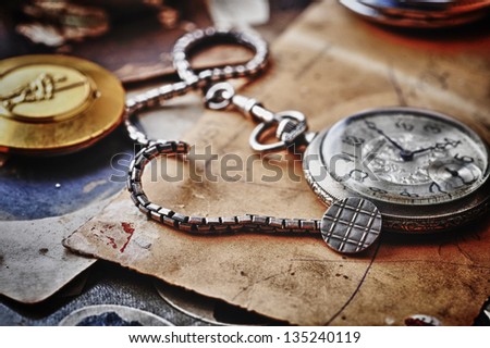 pocket clock with  chain on background of old photos