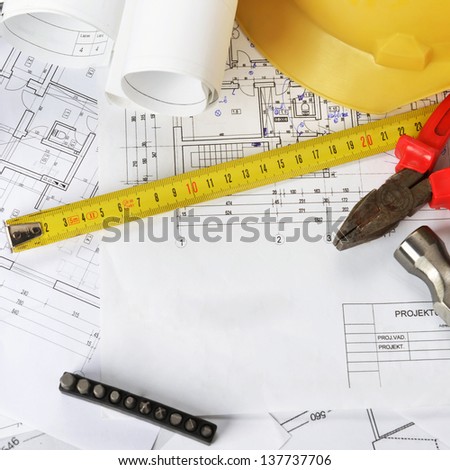 heap of design and project drawings on table background.