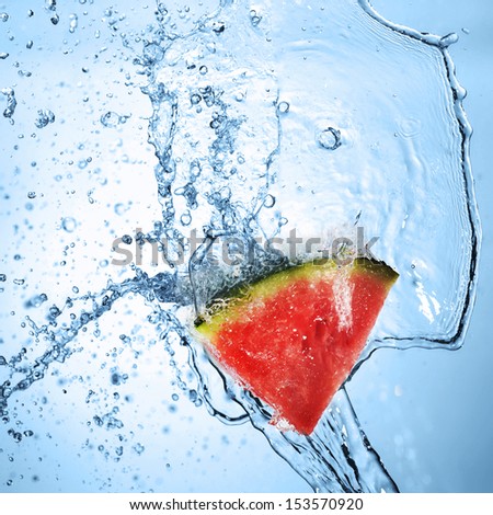 Green apple in splash of water isolated