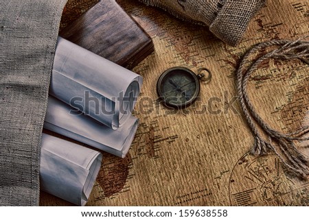 old compass on vintage map and  rope