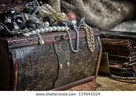 Wooden treasure chest with valuables. beads, necklaces and other jewelry