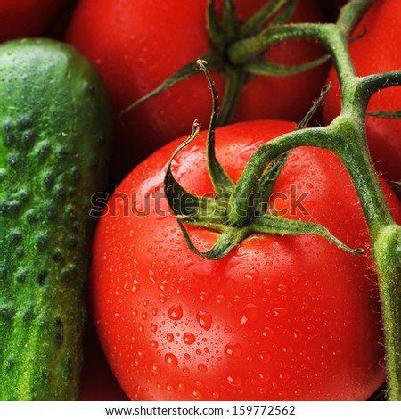 CÂ�ucumbers, red tomatoes lie in  basket