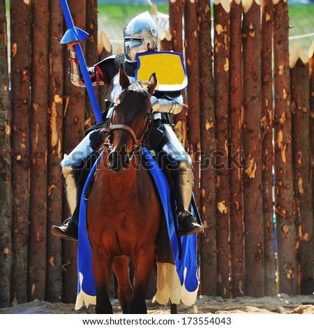 Armored Medieval Knight On Horseback At Jousting Competition