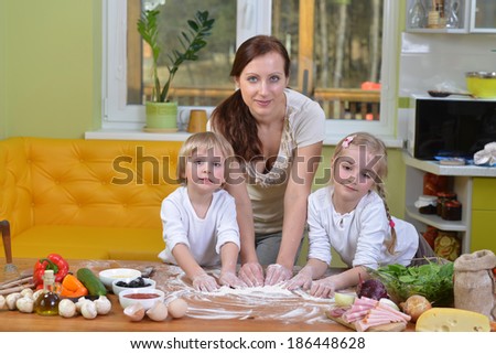 mother with children going to cook pizza