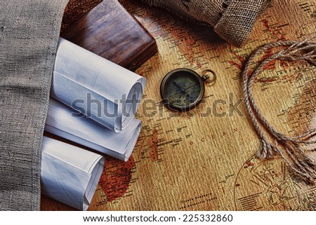old compass on vintage map and  rope