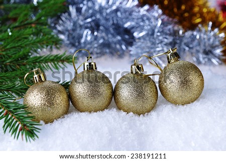 branch of green fir tree with christmas toys on white background