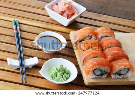 sushi with salmon and avocado on wooden background