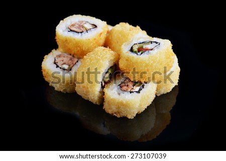 Delicious sushi rolls  on black background