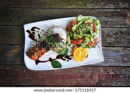 roasted fish,  rice  and vegetables on dish