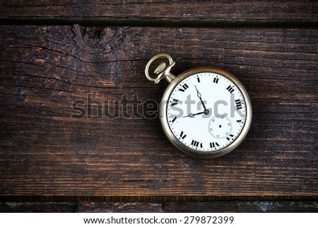 old watch on wooden background