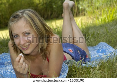 nice girl in red shirt on the grass-plot