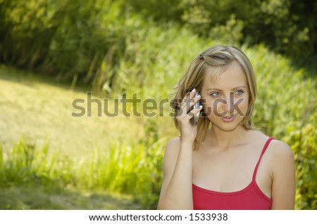 nice girl on the grass-plot with cell phone