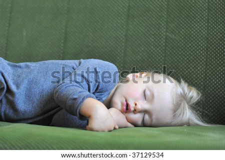 small girl sleeping on the couch