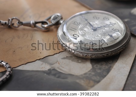 very old watch on the grunge post card and photo