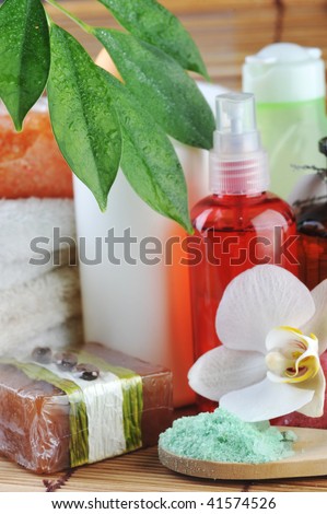 different cosmetics for body and  towel on straw napkin